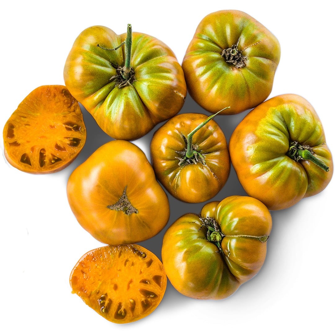 Cut and whole Uluru Ochre Tomatoes arranged on a white background.
