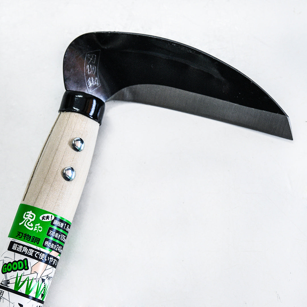 A close-up view a Left Handed Professional Sickle on a light background.
