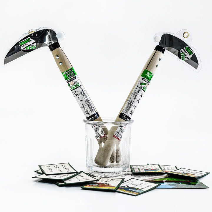 Professional Sickle Right and Left Handed Tools in a glass with Japanese cards on light background.