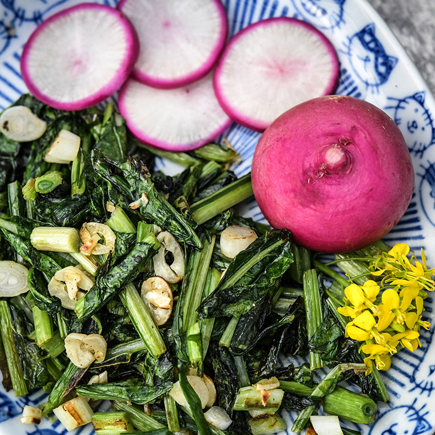 Hida Beni Red Turnip greens sauteed with garlic and garnished with fresh turnips.