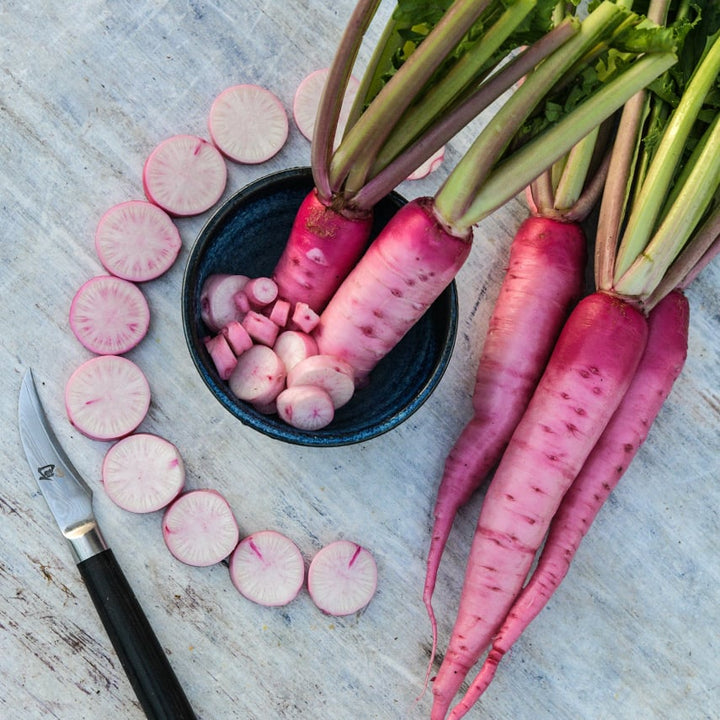 Whole and sliced Asuka Akane Turnips on light background.
