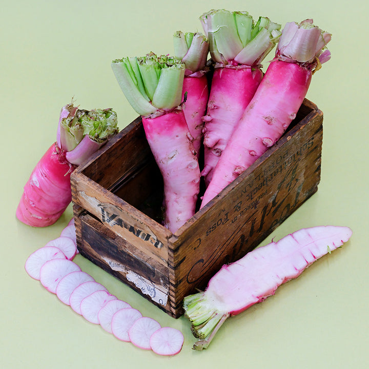 Asuka Akane Turnips in a wood box with slices on light green backgrounds.