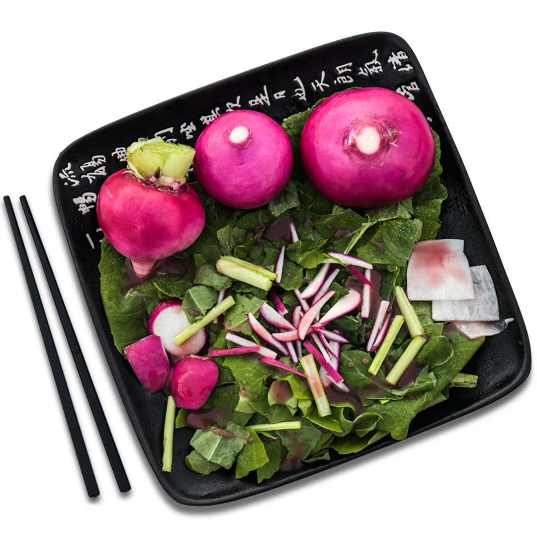 Hida Beni Red Turnips arranged on a Japanese plate with a Japanese chopsticks on a white background.