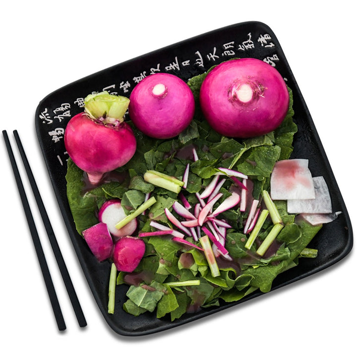 Hida Beni Red Turnips arranged on a Japanese plate with a Japanese chopsticks on a white background.