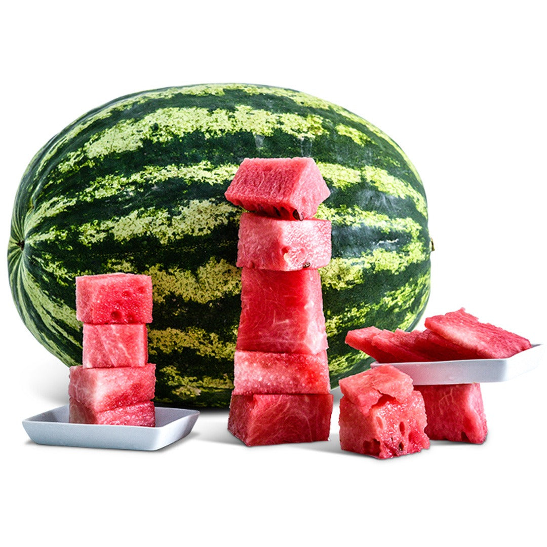 Whole Crimson Sweet Watermelon with watermelon chunks on white plates on a white background.