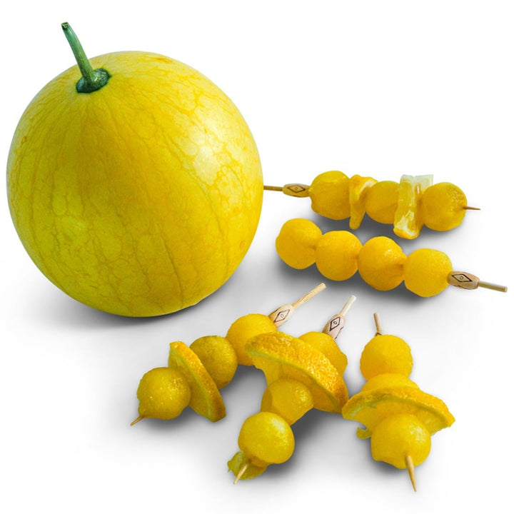 Whole Lemon Drop Watermelon next to balled watermelon and lemon slices on skewers on a white background.