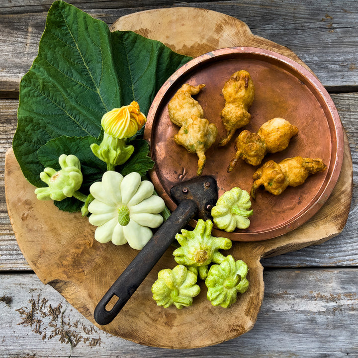 Pineapple Summer Squash cooked in tempura batter on a wood background. Image by Lucy Hutchins.