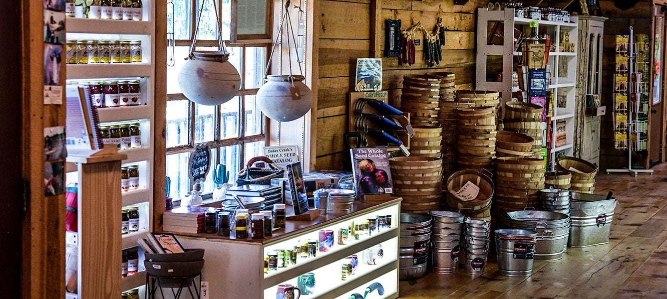 In-store display of baskets, pails, and canned goods at the Baker Creek seed store