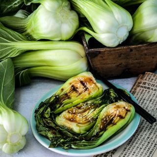 Shanghai Green Bok Choy recipe with fresh bok choy and a Chinese newspaper.