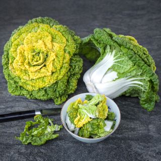 Yellow Heart Winter Choy heads with some leaves in bowl on a stone background.