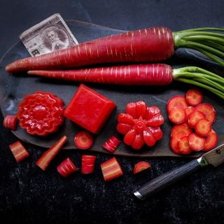Jellied Kyoto Red Carrots with whole and sliced carrots on a ceramic serving platter.