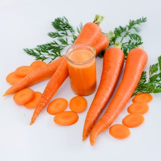 St. Valery Carrots with juice and slices on a white background.