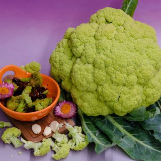 Green Macerata Cauliflower with orange bowl.