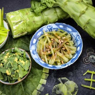 Green Mountain Celtuce Lettuce in various preparations, thin slices, sticks, whole, raw and cooked on a black background