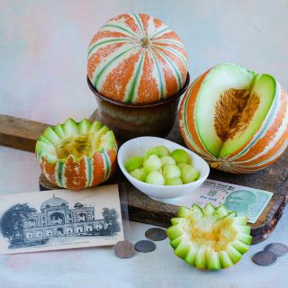 Kajari Melon with wedge removed and top decoratively removed.