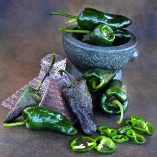 Poblano Peppers and slices with miniature Pyramid sculpture.