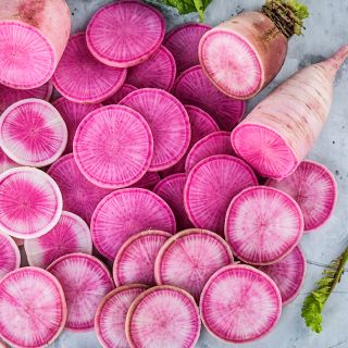 Cut Pusa Gulabi Radishes on a light background.