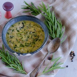 Rosemary soup on light tan, checkered table cloth.
