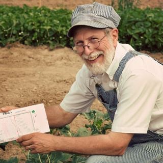 Clyde showing off his amazing Clyde's Garden Planner in the Baker Creek gardens.