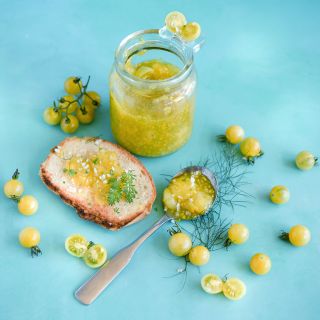 White Currant Tomato with tomato jam on bread on light blue background.