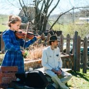 A young violinist plays her instrument at the Baker Creek Tulip Festival.