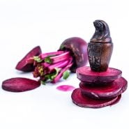 A close-up view of Crosby's Egyptian Beet slices with a small canopic jar replica on a bright white background.