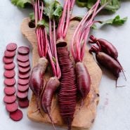 Sliced Cylindra Beets on cutting board.