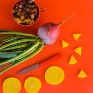 Golden Beets on an orange background with Roasted Beet Salad.