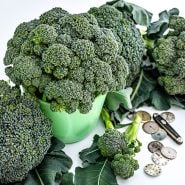Rasmus Broccoli heads with watch faces and a Swiss knife on a white background.