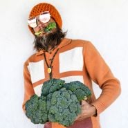 Ryan stylin' in orange 70s attire with a bouquet of Rasmus Broccoli.