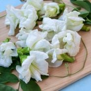 White Butterfly Pea on wooden cutting board.