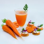 Juiced, sliced and whole Danvers 126 Half Long Carrots with some slices on crackers.