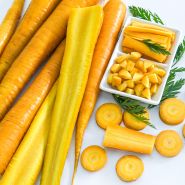 Cut and whole Jaune Obtuse du Doubs carrots on a white background.