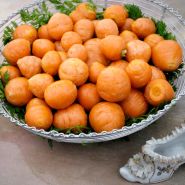 Parisienne Carrots in metal basket with a ceramic French shoe.