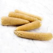 Amish Butter Popcorn cobs arranged on a white marble countertop.