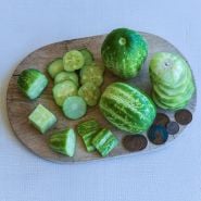 Richmond Green Apple Cucumbers in varying preparations on cutting board.
