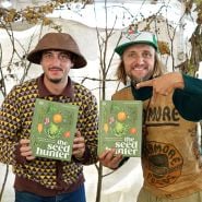 Author Mitch poses with Ryan wilst showing off his amazing book at the Baker Creek Fall Harvest Festival.
