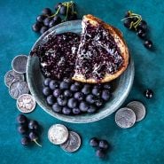 Wonderberry jam with Wonderberries on a teal background with coins.