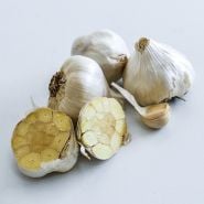 Chet's Italian Garlic bulbs with a halved bulb and a clove on a white background.