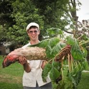 Jere Gettle with a Mammoth Red Mangel Beet at the Baker Creek Farm.