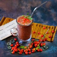 Scarlet Goji Berries with a smoothie on a dark blue background. 