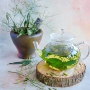 King of Bitters (Fah Taloi Jone) in a tea with some leaves in a mortar and pestle.