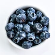 Overhead view of bowl of Top Hat Blueberries on a white background.