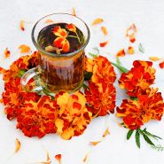 Safari Scarlet Marigolds with tea made from the marigolds on a light background.