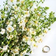 White Bride Mullein flowers with a wedding ring on white background.