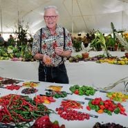 A speaker poses with some peppers at the Baker Creek Fall Harvest Festival.