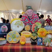 Fruit carver Carl Jones poses with his art at the Baker Creek Fall Harvest Festival.