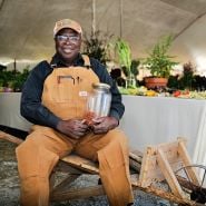 A speaker poses with his cowpeas at the Baker Creek Fall Harvest Festival.