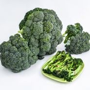 Rasmus Broccoli heads with a plate of cooked broccoli on a white background.