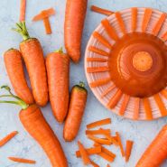 New Kuroda Carrots with a plate of carrot jello on a light background.